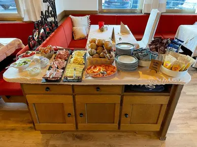 a table filled with food on top of a couch at Pension Dolomieu in Santa Cristina in Val Gardena