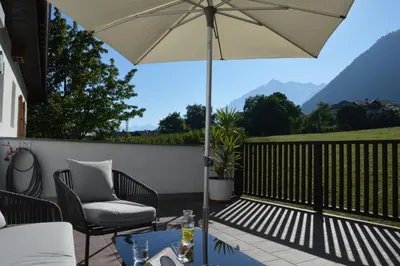 a patio with a table and an umbrella at Apartment Pyrus in Tirolo