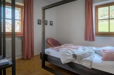 a bedroom with a bed and a mirror at Apartment Pyrus in Tirolo