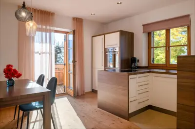 a kitchen with a table and a dining room at Apartment Pyrus in Tirolo