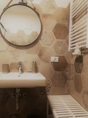 a bathroom with a sink and a mirror at Appartamento Angelo in Selva di Val Gardena