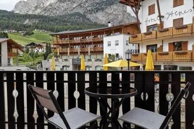 a couple of chairs sitting on top of a balcony at Appartamento Angelo in Selva di Val Gardena
