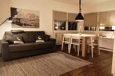 a living room with a couch and a table at Appartamento Angelo in Selva di Val Gardena