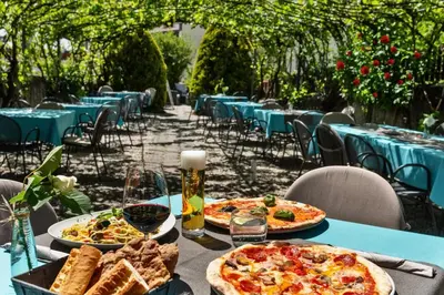 a table with two pizzas and bread on it at Hotel Villa Mayr Rooms & Suites in Brixen