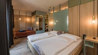a bedroom with a large bed in a room at Hotel Villa Mayr Rooms & Suites in Brixen