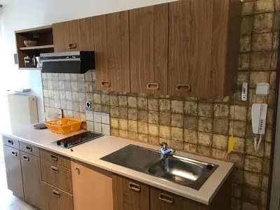 a kitchen with a sink and wooden cabinets at Haus Michael in Villabassa