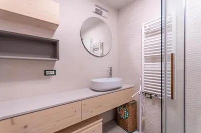 a bathroom with a sink and a mirror at Casa Piz Meda in Soraga