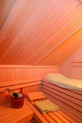 a sauna with a bed and a bucket in it at viaDolceVita - Blaue Gästewohnung in Lana