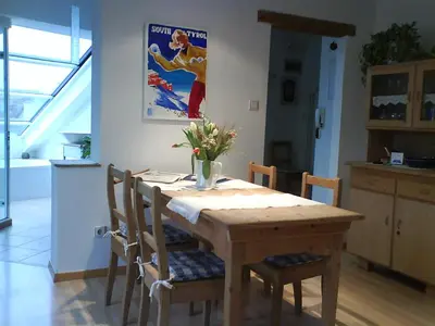 a wooden table in a kitchen with a dining room at viaDolceVita - Blaue Gästewohnung in Lana