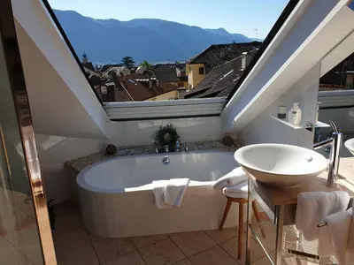 a bathroom with a bath tub and a sink at viaDolceVita - Blaue Gästewohnung in Lana