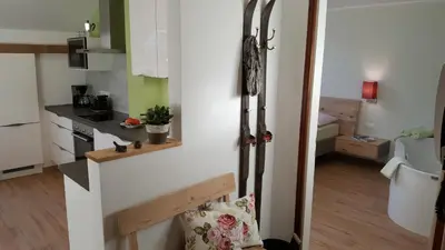 a small kitchen with a counter and a room at viaDolceVita - Grüne Gästewohnung in Lana