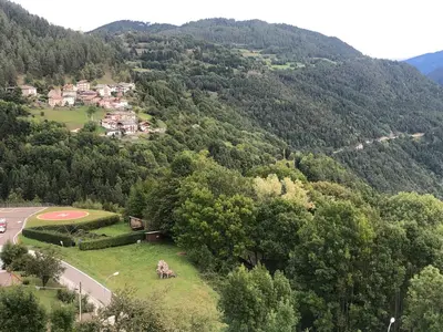 an aerial view of a village in the mountains at B and B nonna Rosa vista Lagorai in Capriana