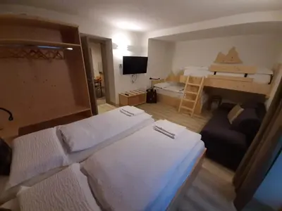a small room with two beds and a desk at B and B nonna Rosa vista Lagorai in Capriana