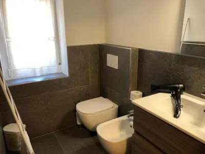 a bathroom with a toilet and a sink at B and B nonna Rosa vista Lagorai in Capriana