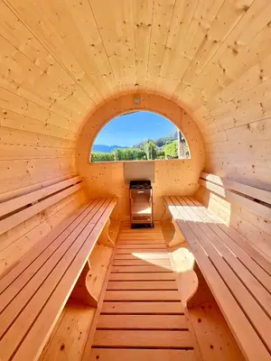 a living room with a couch and a large window at Weingut Gasshof in Appiano sulla Strada del Vino