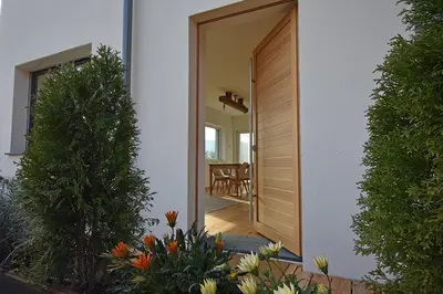 a door to a house with a dining room at Casa Alpina in Cavalese