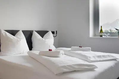 two white beds with white pillows and a window at CasaLuNa in Appiano sulla Strada del Vino