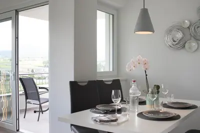 a dining room with a table with glasses and flowers on it at CasaLuNa in Appiano sulla Strada del Vino