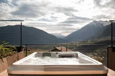 a bath tub with a view of a mountain at View House - Chalet Goyen in Schenna