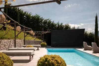 a swimming pool with a large screen in a backyard at View House - Chalet Goyen in Schenna