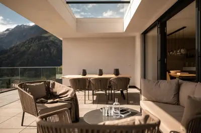 a living room with a couch and chairs and a table at View House - Chalet Goyen in Schenna