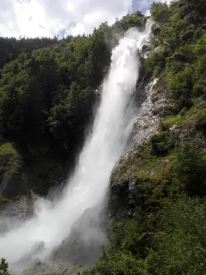 a waterfall on the side of a mountain at Fewo Windbichl in Parcines