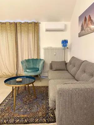 a living room with a couch and a table at Emma Suite Merano in Merano