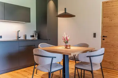 a dining room with a wooden table and chairs at Kandlerhof in Bolzano