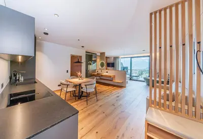 a kitchen and living room with a table and chairs at Kandlerhof in Bolzano