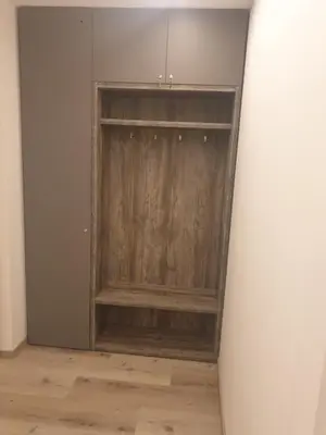 a surfboard standing in front of a wooden closet at Roma Ariston 7 in Bolzano