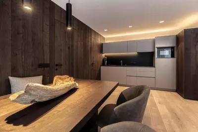 a dining room with a wooden table and chairs at Villa Margareth in Selva di Val Gardena