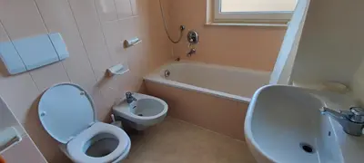 a bathroom with a toilet and a tub and a sink at CASA CAVALESE in Cavalese
