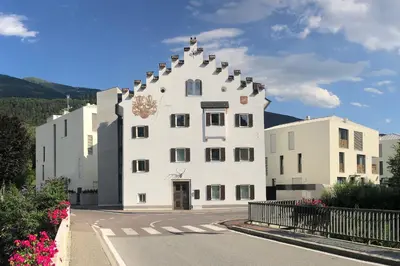 a large white building with a pointed roof at Apartments Griesser - Included BrixenCard and parking garage in house in Bressanone