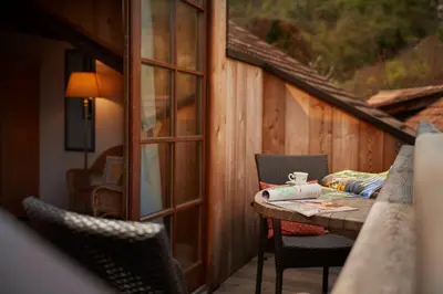a table and chairs on the balcony of a cabin at Ferienapartments Gutshof Brandis in Lana