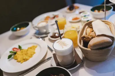 a table topped with plates of food and drinks at Ferienapartments Gutshof Brandis in Lana