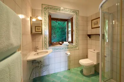 a bathroom with a toilet and a sink and a mirror at Ferienapartments Gutshof Brandis in Lana