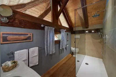 a bathroom with a toilet and a glass shower at Ferienapartments Gutshof Brandis in Lana