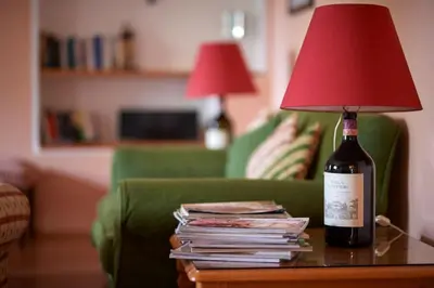 a bottle of wine sitting on a table with a lamp at Ferienapartments Gutshof Brandis in Lana
