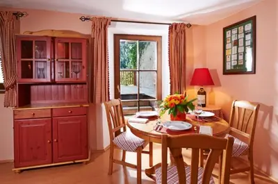 a kitchen with a table and a dining room at Ferienapartments Gutshof Brandis in Lana