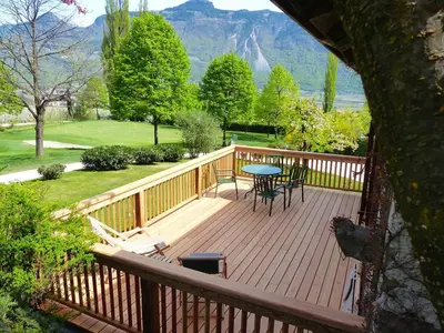 a wooden deck with a table and chairs on it at Ferienapartments Gutshof Brandis in Lana