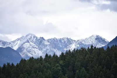 a mountain range with snow capped mountains in the distance at Panoramaresidence Hafling in Avelengo