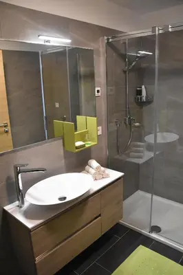 a bathroom with a sink and a shower at Panoramaresidence Hafling in Avelengo