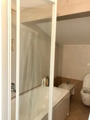a bathroom with a white tub and a toilet at Appartamento Primiero San Martino di Castrozza in Fiera di Primiero