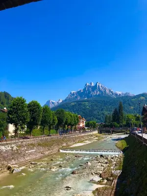 a river with a mountain in the background at Appartamento Primiero San Martino di Castrozza in Fiera di Primiero