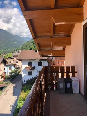 a balcony of a house with a wooden roof at Appartamento Primiero San Martino di Castrozza in Fiera di Primiero