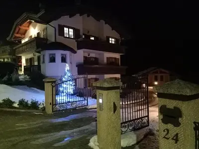 a house with a gate at night with a christmas tree at Apartment El Cor in Taibon