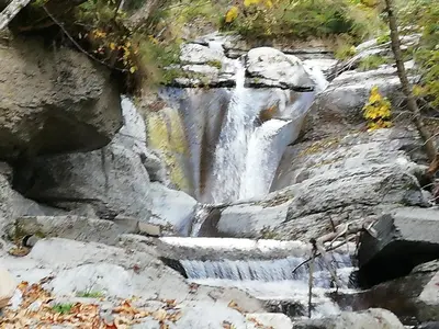 a waterfall on the side of a rocky hill at Apartment El Cor in Taibon