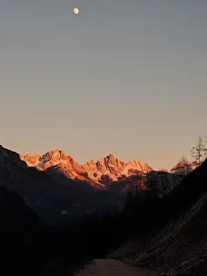 a mountain range with the sun shining on it at Apartment El Cor in Taibon