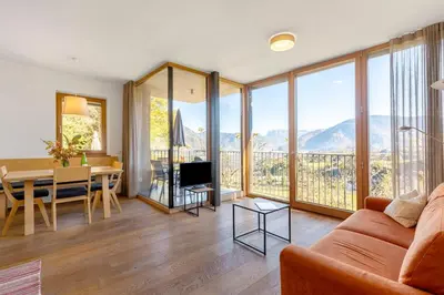 a living room with a couch and a table with a view at Firmelein in Appiano sulla Strada del Vino