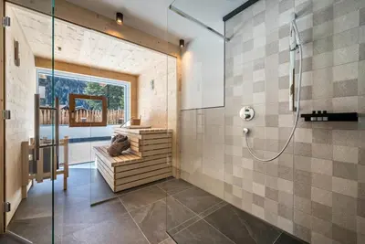 a bathroom with a shower with a glass door at MULIN Appartements in Valles